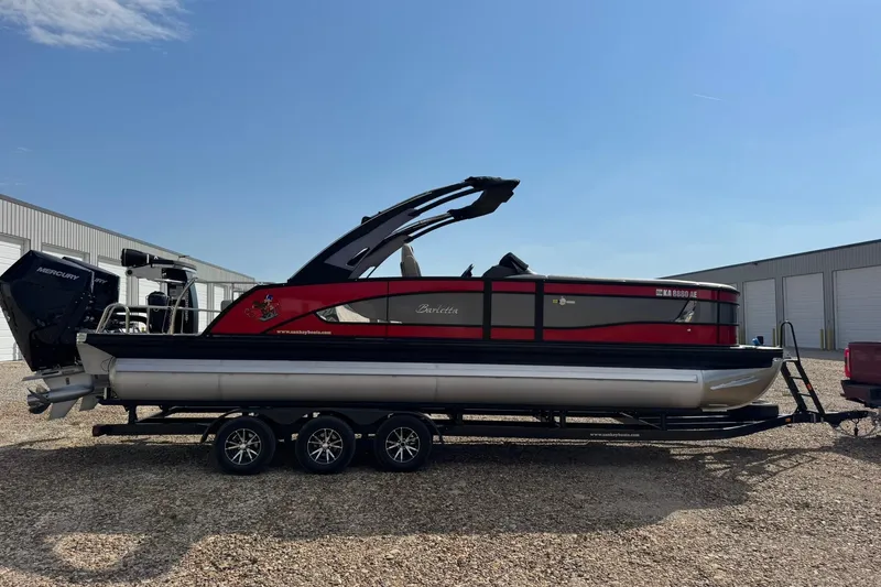 Slide: The Image of 2025 Barletta LUSSO 25UCAT pontoon boat on trailer, parked outdoors. - 13