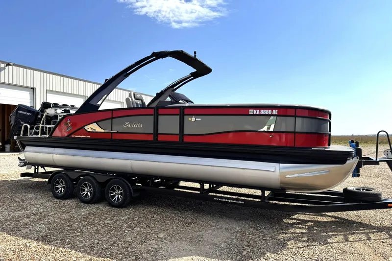 Slide: The Image of 2025 Barletta LUSSO 25UCAT pontoon boat on trailer, red and black design. - 14