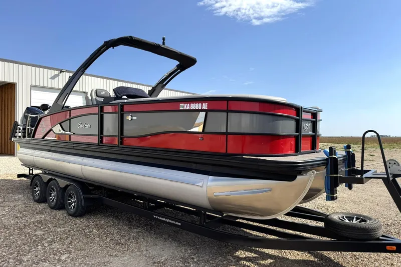 Slide: The Image of 2025 Barletta LUSSO 25UCAT pontoon boat on trailer, red and black design. - 15