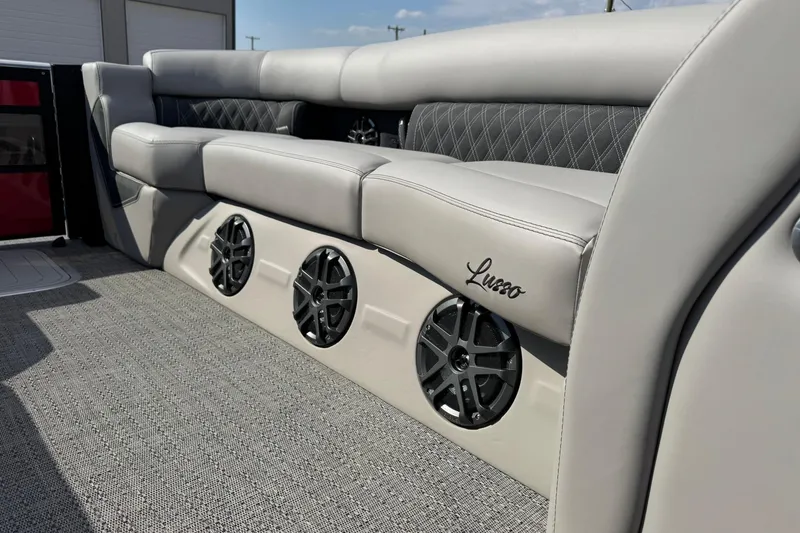 Slide: The Image of 2025 Barletta LUSSO 25UCAT boat interior with luxurious seating and built-in speakers. - 24