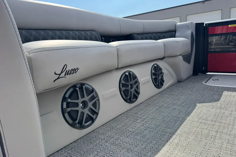 Slide: The Image of 2025 Barletta LUSSO 25UCAT boat interior with luxurious seating and built-in speakers. - 25