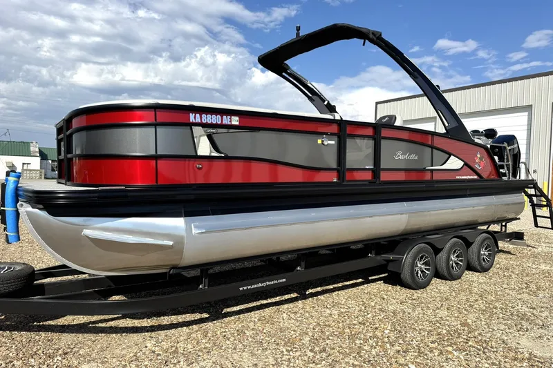 Slide: The Image of 2025 Barletta LUSSO 25UCAT pontoon boat on trailer, red and black design. - 3
