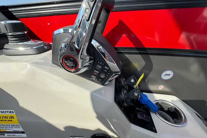Slide: The Image of Control panel of 2025 Barletta LUSSO 25UCAT boat with throttle and ignition keys. - 33