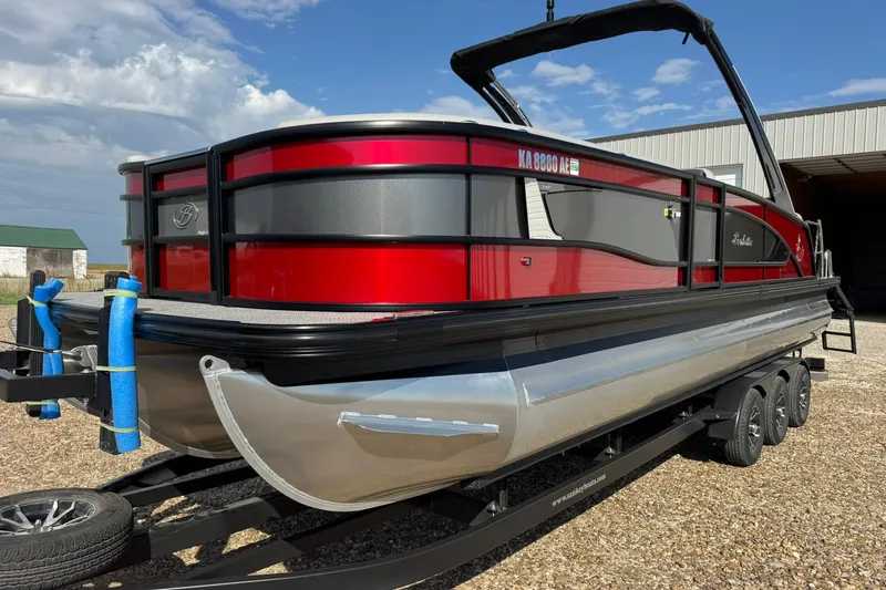 Slide: The Image of 2025 Barletta LUSSO 25UCAT pontoon boat on trailer, red and black design. - 4
