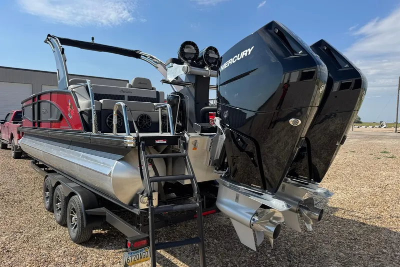 Slide: The Image of 2025 Barletta LUSSO 25UCAT pontoon boat with dual Mercury engines on a trailer. - 8