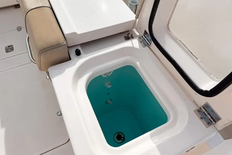 Slide: The Image of Livewell on 2016 Pursuit OS 355 Offshore boat, open with water inside. - 12