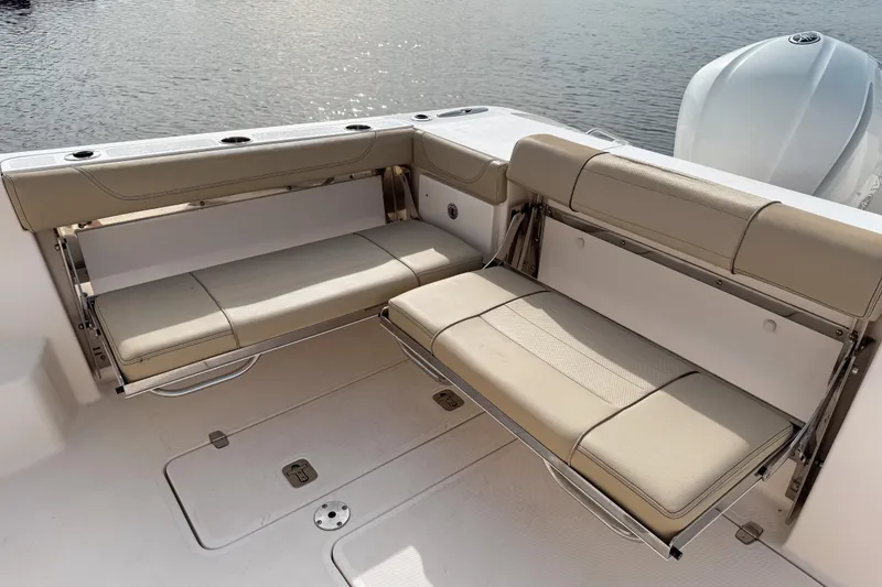 Slide: The Image of 2016 Pursuit OS 355 Offshore boat with beige foldable seating on deck. - 13