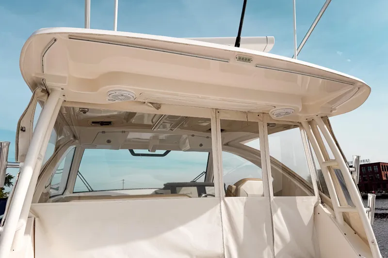 Slide: The Image of 2016 Pursuit OS 355 Offshore boat with covered cockpit and clear skies. - 19