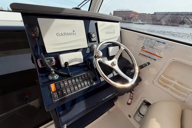 Slide: The Image of 2016 Pursuit OS 355 Offshore helm with Garmin navigation system and steering wheel. - 23
