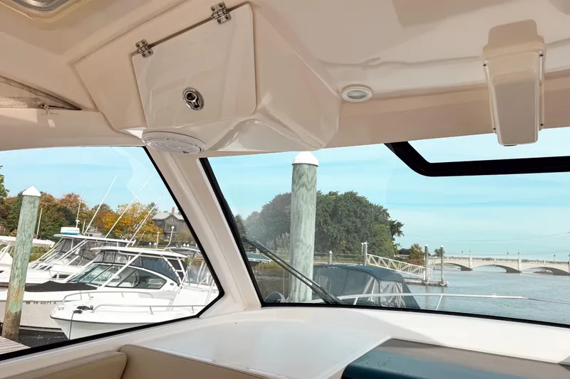 Slide: The Image of Interior view from a 2016 Pursuit OS 355 Offshore boat docked at a marina. - 28