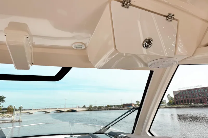 Slide: The Image of Interior view of 2016 Pursuit OS 355 Offshore boat with waterway and bridge in background. - 29