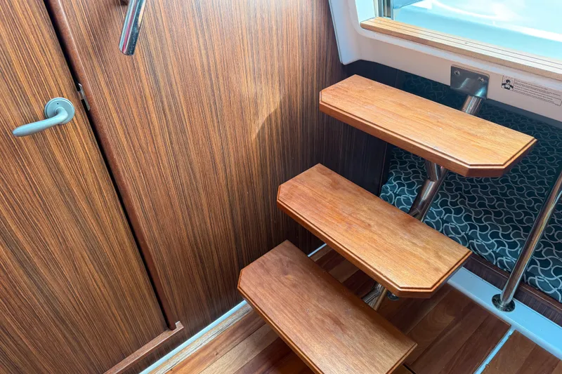 Slide: The Image of Wooden interior stairs on a 2016 Pursuit OS 355 Offshore boat. - 32