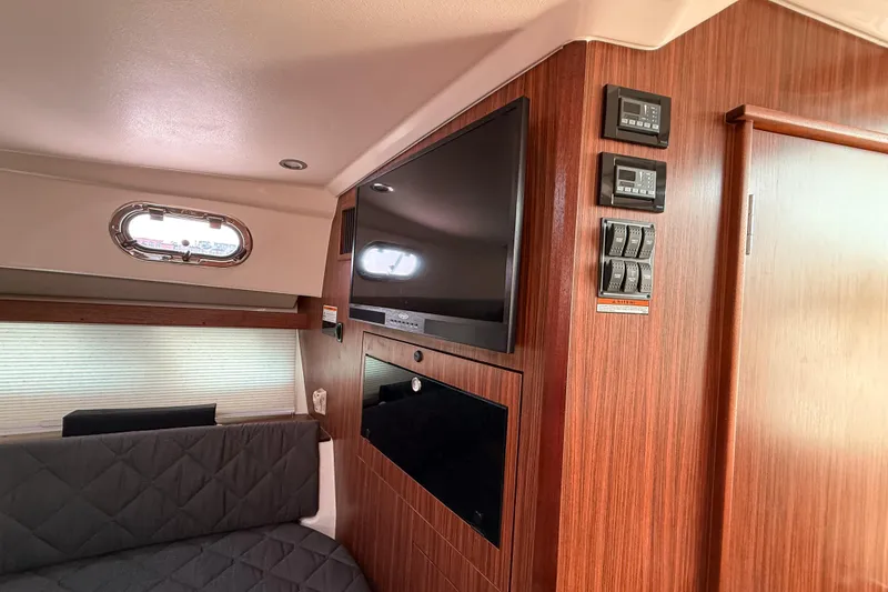 Slide: The Image of Interior of 2016 Pursuit OS 355 Offshore boat with wood paneling and modern amenities. - 34