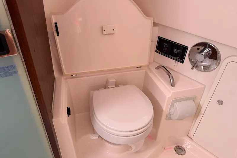 Slide: The Image of 2016 Pursuit OS 355 Offshore boat bathroom with toilet and sink. - 39