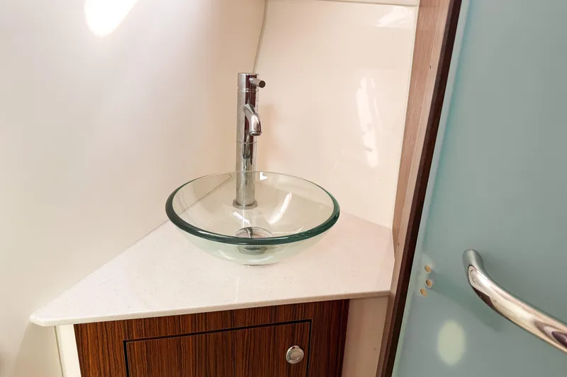 Slide: The Image of Glass vessel sink in 2016 Pursuit OS 355 Offshore boat bathroom. - 40