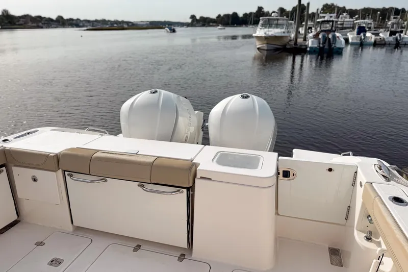 Slide: The Image of 2016 Pursuit OS 355 Offshore boat with dual engines docked at marina. - 7