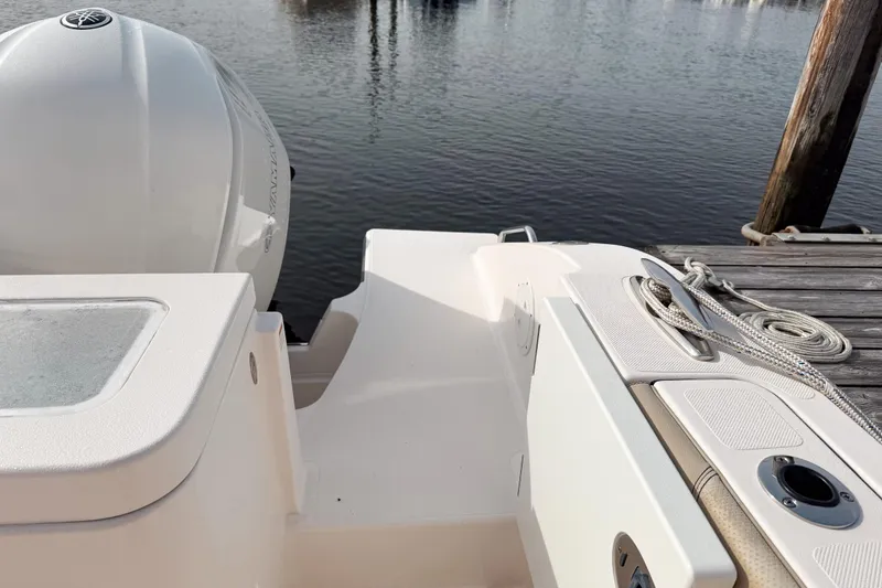 Slide: The Image of 2016 Pursuit OS 355 Offshore boat docked, featuring Yamaha outboard motor and deck details. - 9