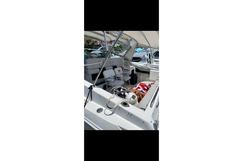 Slide: The Image of 1990 Sea Ray 350 Sundancer boat interior with seating and canopy. - 4