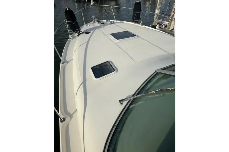 Slide: The Image of 2000 Sea Ray 310 Sundancer boat deck with hatches, docked in marina. - 13