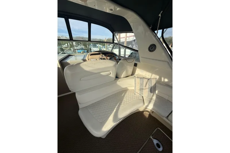 Slide: The Image of Interior of 2000 Sea Ray 310 Sundancer boat with white seating and helm. - 15