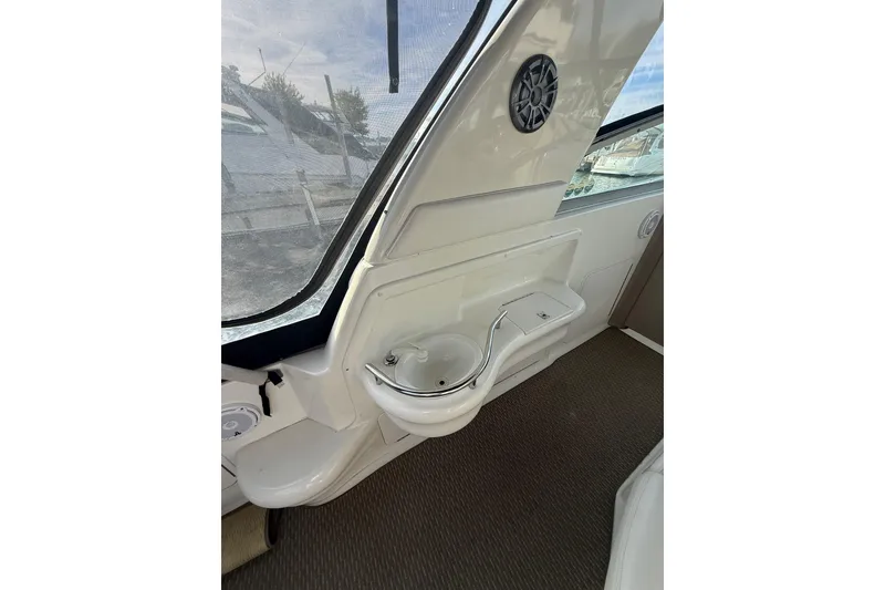 Slide: The Image of Interior view of 2000 Sea Ray 310 Sundancer boat, featuring a compact sink and speaker. - 16