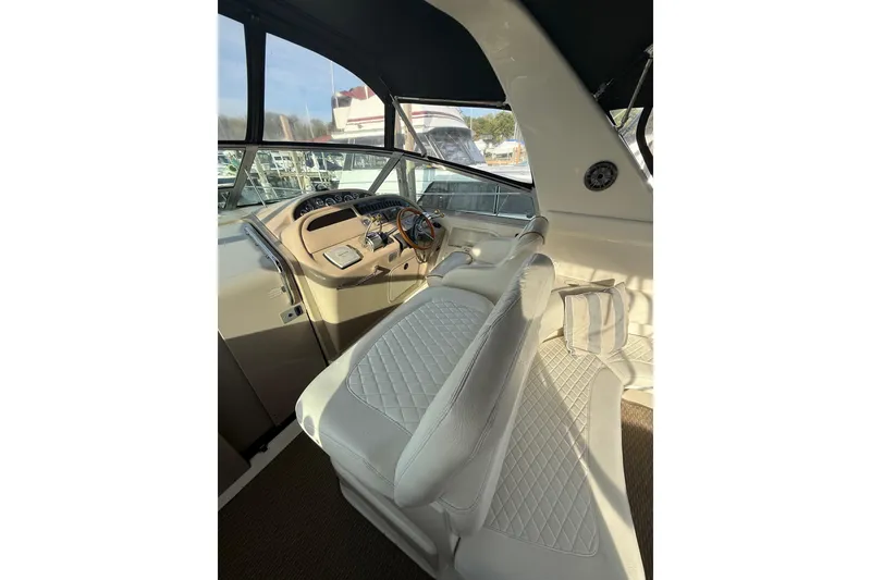 Slide: The Image of Interior of 2000 Sea Ray 310 Sundancer boat with white seating and control panel. - 17