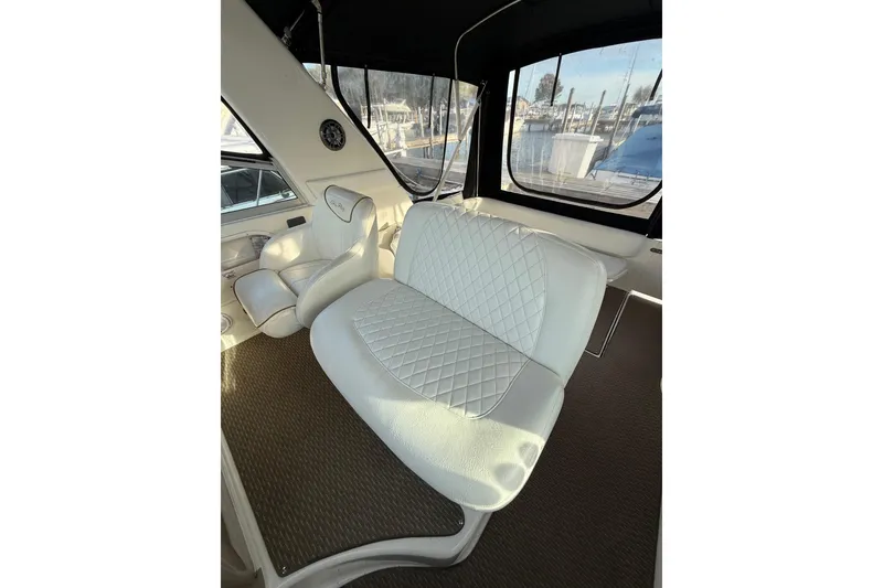 Slide: The Image of Interior of 2000 Sea Ray 310 Sundancer with white leather seating and panoramic windows. - 18