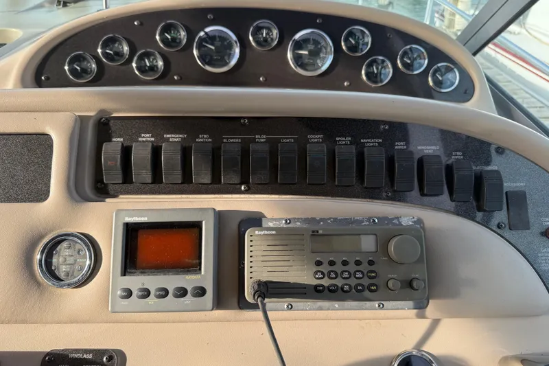 Slide: The Image of Control panel of a 2000 Sea Ray 310 Sundancer boat with gauges and switches. - 21