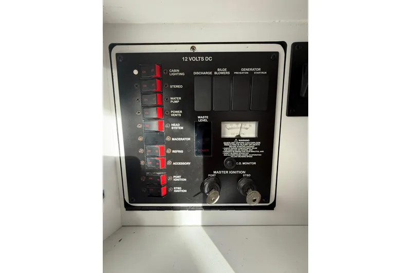Slide: The Image of Control panel of a 2000 Sea Ray 310 Sundancer boat, featuring various switches and gauges. - 34