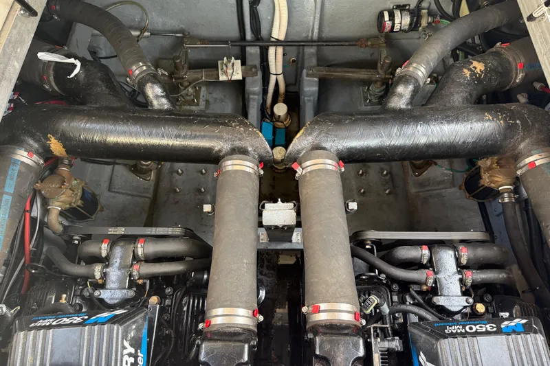 Slide: The Image of Engine compartment of a 2000 Sea Ray 310 Sundancer boat, showcasing dual engines and exhaust system. - 36