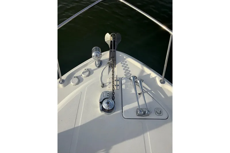 Slide: The Image of Bow of 2000 Sea Ray 310 Sundancer with anchor and railing in sunlight. - 9