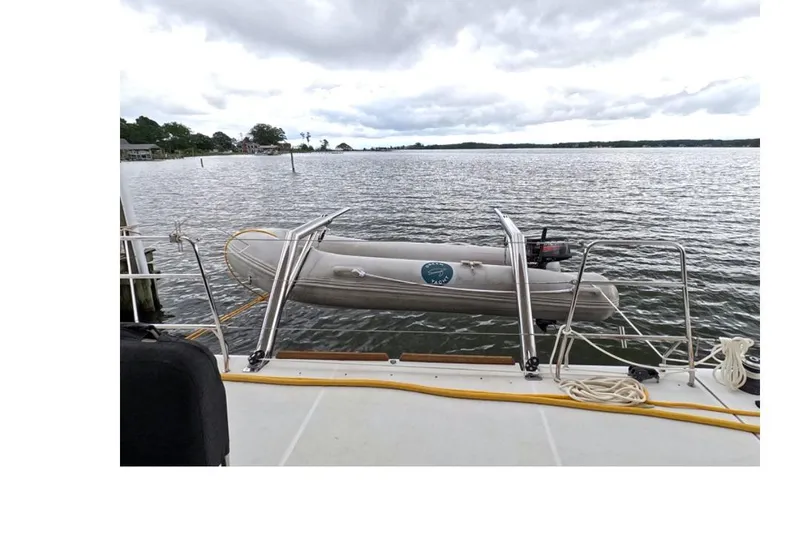 Slide: The Image of Lagoon 52 F yacht with dinghy on calm waters, 2021 model. - 11