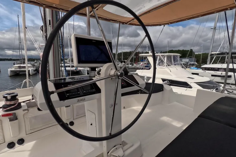 Slide: The Image of Helm of 2021 Lagoon 51 catamaran with navigation equipment, docked at marina. - 17
