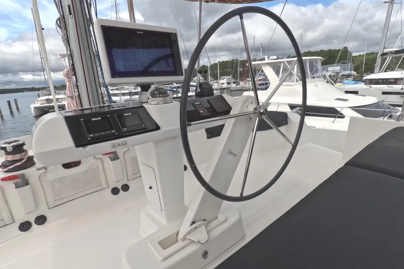 Slide: The Image of Cockpit of 2021 Lagoon 51 yacht with steering wheel and navigation equipment. - 18