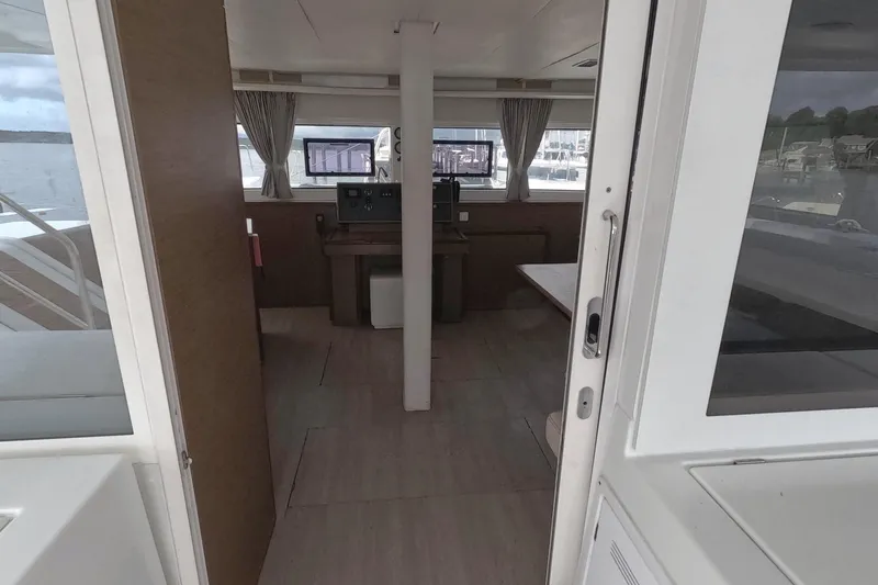 Slide: The Image of Interior view of 2021 Lagoon 51 yacht, featuring navigation area and windows. - 25