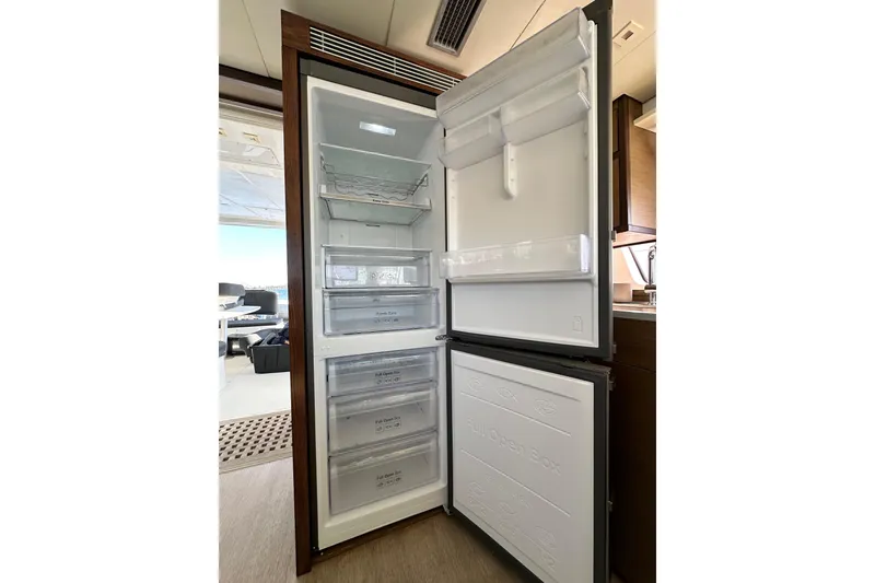 Slide: The Image of Open refrigerator inside 2021 Lagoon 52 F yacht, showcasing spacious interior and modern design. - 27