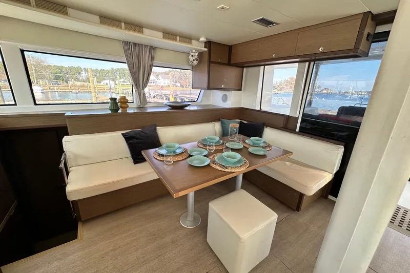 Slide: The Image of Interior of 2021 Lagoon 52 F yacht with elegant dining area and scenic window views. - 28