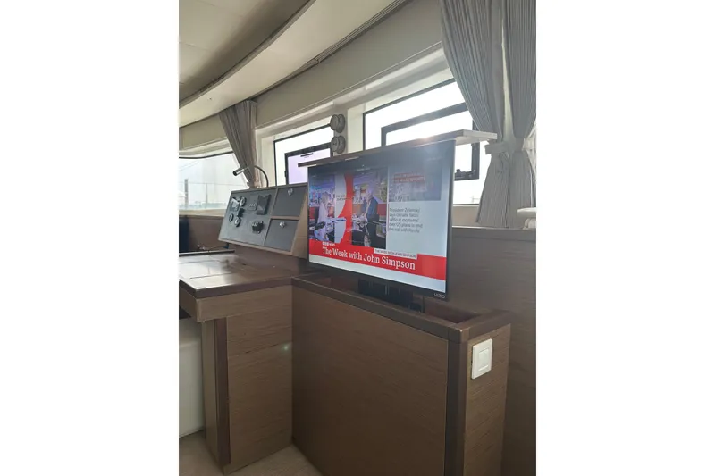 Slide: The Image of Interior of 2021 Lagoon 52 F yacht with TV and control panel. - 29