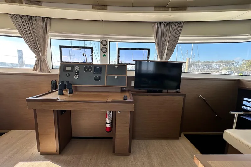 Slide: The Image of Luxurious interior of 2021 Lagoon 52 F yacht with navigation station and TV. - 30