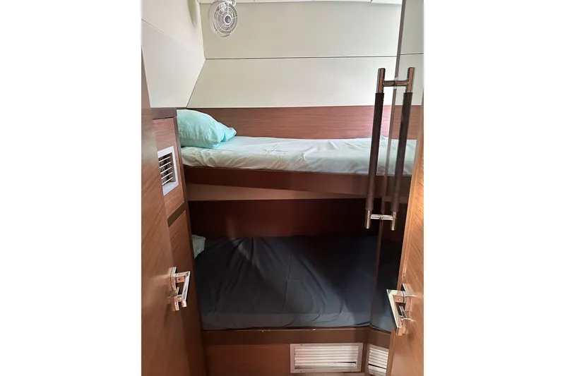 Slide: The Image of 2021 Lagoon 52 F yacht interior with bunk beds and modern wood finish. - 33