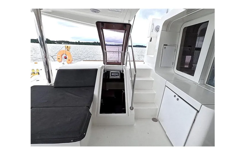Slide: The Image of 2021 Lagoon 52 F yacht interior with seating, stairs, and water view. - 39