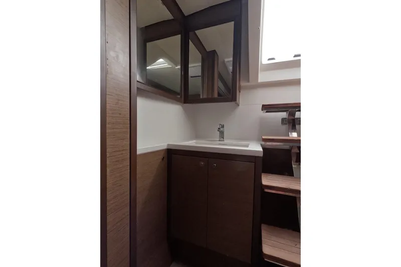 Slide: The Image of Modern bathroom interior of 2021 Lagoon 51 yacht with wooden cabinetry and mirror. - 40