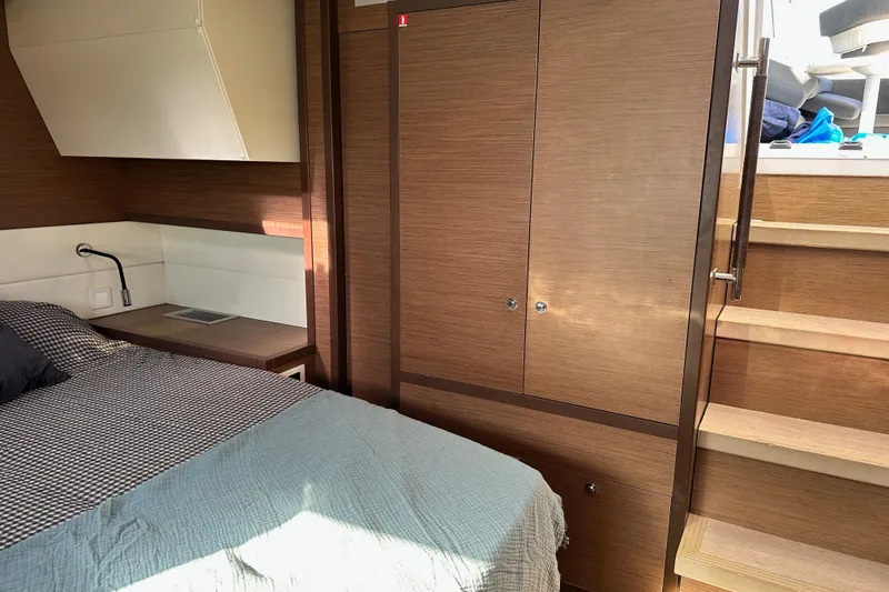 Slide: The Image of Luxurious interior cabin of 2021 Lagoon 52 F yacht with wooden finishes and cozy bedding. - 41