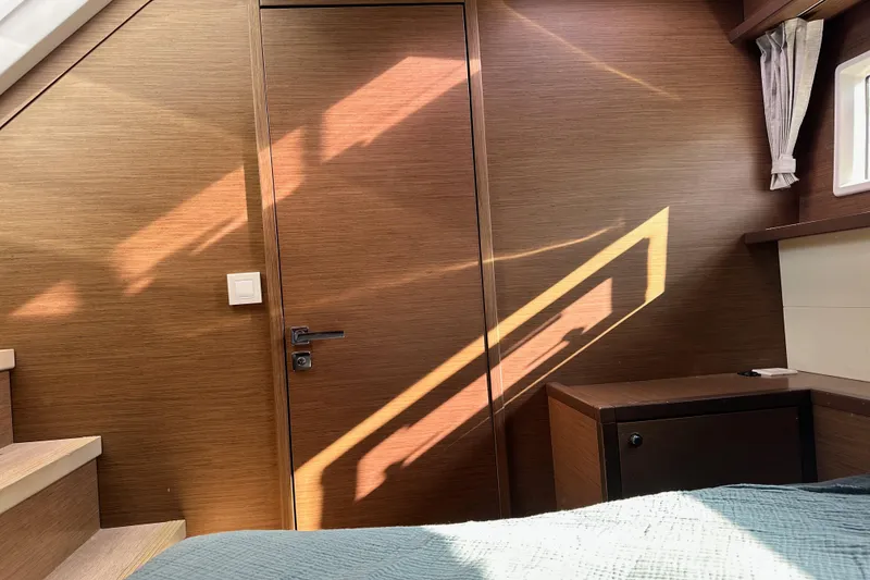 Slide: The Image of Interior of 2021 Lagoon 52 F yacht cabin with wooden finish and natural light. - 43