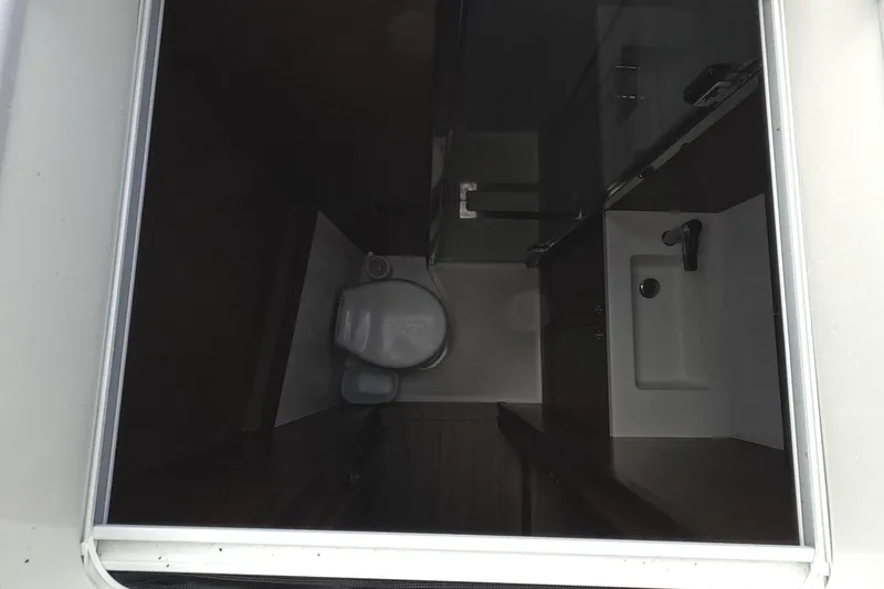 Slide: The Image of Compact bathroom interior of 2021 Lagoon 51 yacht, featuring toilet and sink. - 45