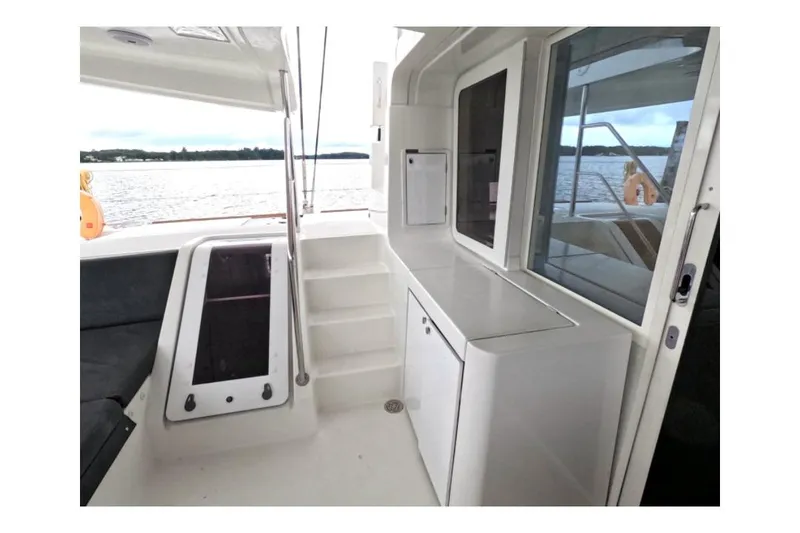 Slide: The Image of 2021 Lagoon 52 F yacht interior with sleek white cabinetry and waterfront view. - 6