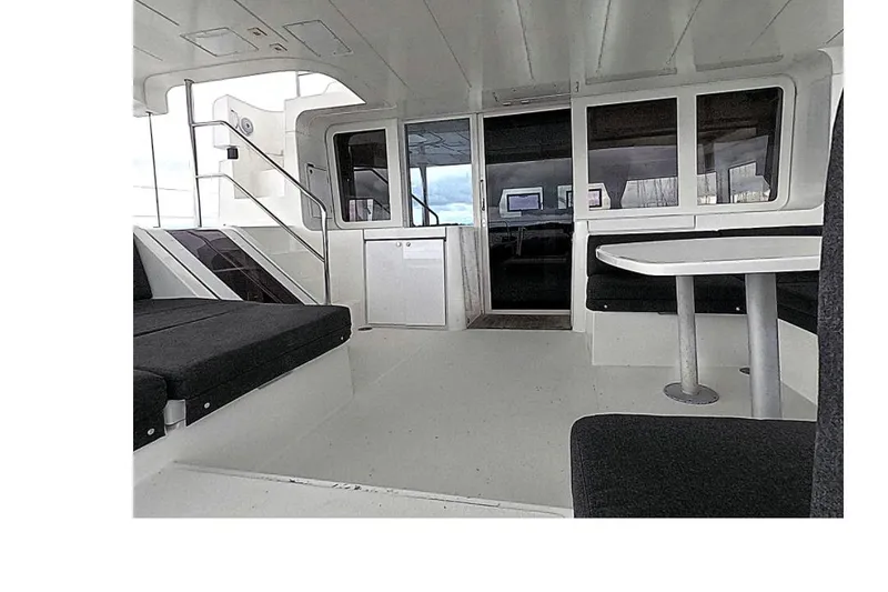 Slide: The Image of Interior of 2021 Lagoon 52 F yacht, featuring seating and a table. - 7