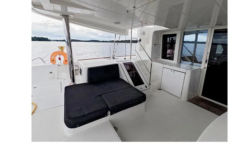 Slide: The Image of 2021 Lagoon 52 F yacht interior with seating, overlooking serene water view. - 8