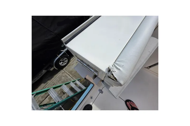 Slide: The Image of Damaged upholstery on 2022 Cobia 320 Center Console boat, showing wear and tear. - 25