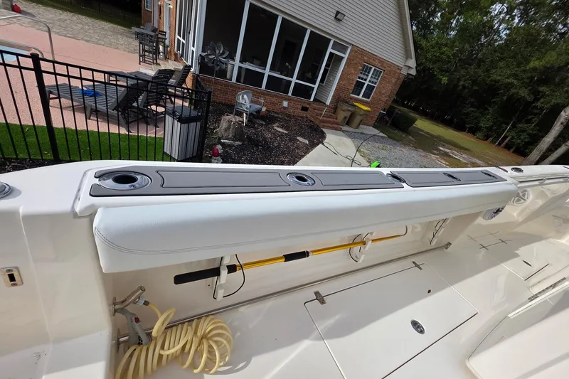 Slide: The Image of 2022 Cobia 320 Center Console boat interior with seating and storage compartments. - 28